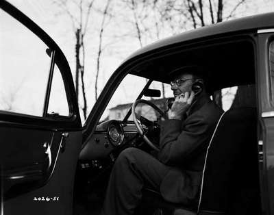 Unidentified Man Sitting in a Truck Cab Talking on the Phone