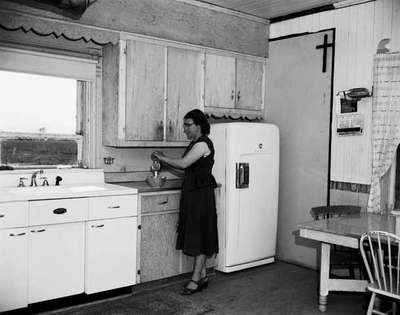 Unidentified Woman Standing in a Kitchen