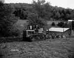 Crawler Tractor Equipped with a Plough