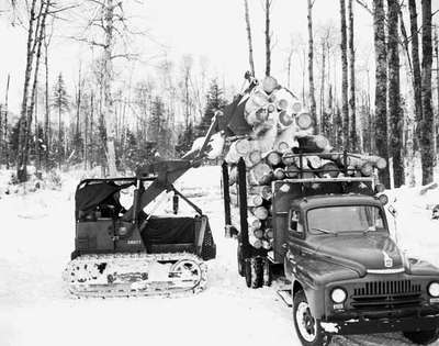 Crawler Tractor Loading Logs onto Truck, Cameron Falls, ON