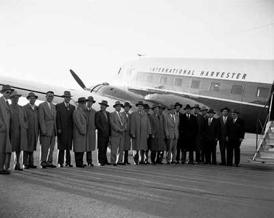 International Harvester officials meet Charles Cusson at Montreal's Dorval airport.