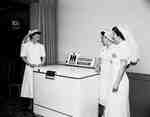 Three Female Nurses Standing Next to a Home Freezer, Hamilton, ON