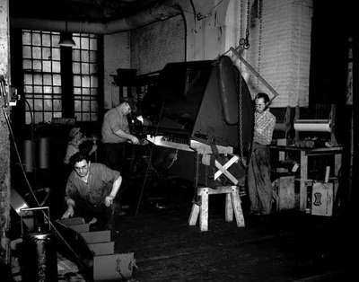 Unidentified Workers Using a Packaging Baler