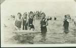 Children playing with a model ship at the Wilmette beach