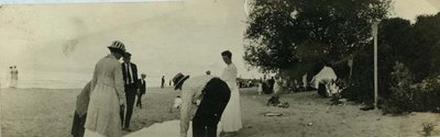 People spreading a blanket on the Wilmette beach about 1918