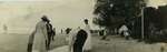 People spreading a blanket on the Wilmette beach about 1918