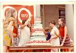 Mrs. Armon Lund and children with Centennial cake