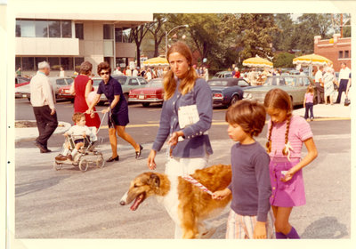 Woman and children walking a dog