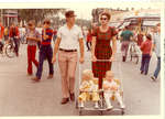 Man and woman pushing a stroller with two children