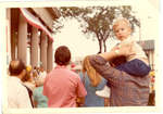 Child on his parents shoulders