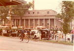 Child riding a bicycle past Village Hall