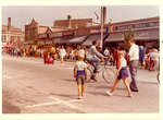 People walking in the street past Madame Baba Modiste