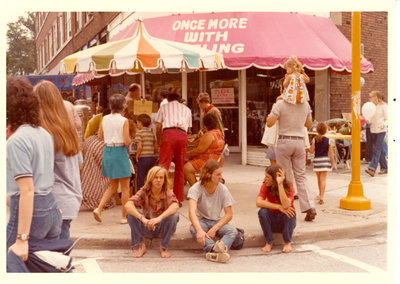 Young people on the sidewalk in front of Once More With Feeling