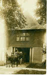 Wilmette Fire Station with horse-drawn fire truck wagon emerging from the building