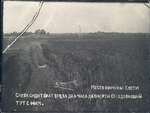 A son of Nikolai Bokan is pictured sitting in a field, in the spot where his brother Konstantin had died only a few hours earlier