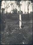 Nikolai Bokan stands beside the grave of his son Konstantin, who died of starvation